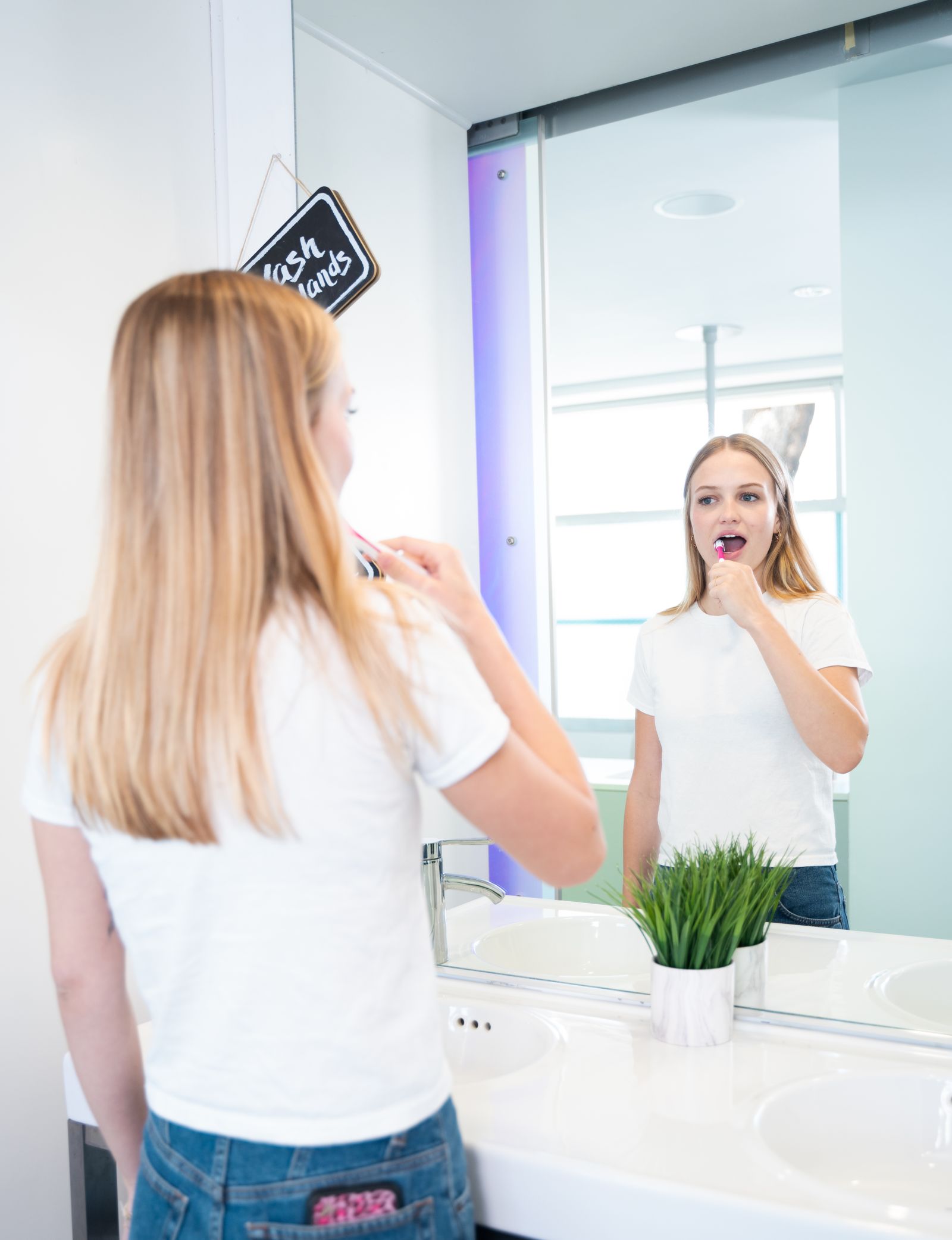 A teenager at the practice's brushing station