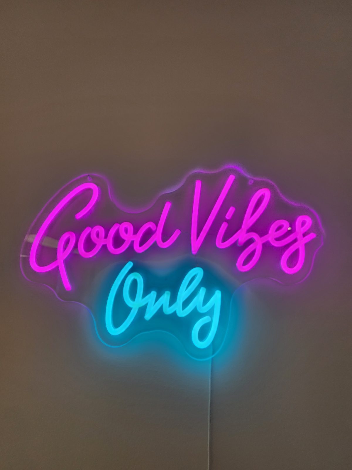 A neon sign reading Good Vibes Only on the wall of the Downtown Los Angeles office