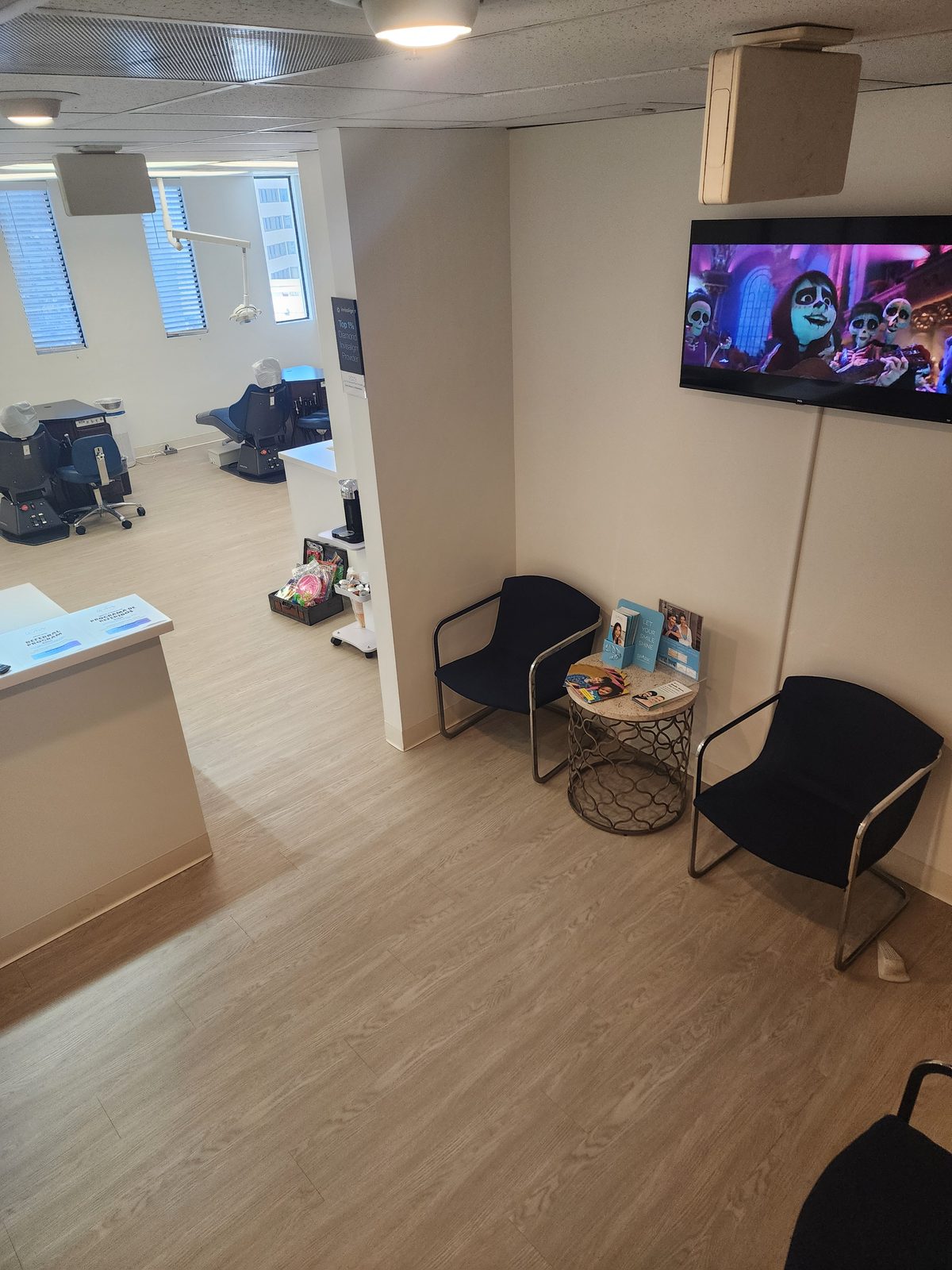 Seating and a wall-mounted screen in the Downtown Los Angeles waiting area