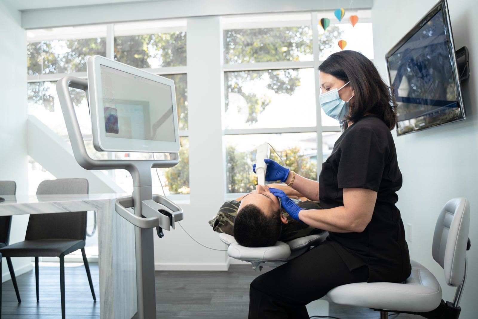 Dr. Khan with an adult patient at the chair