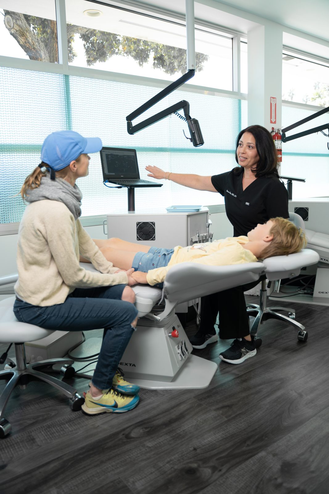 Dr. Khan talking with a parent and their child